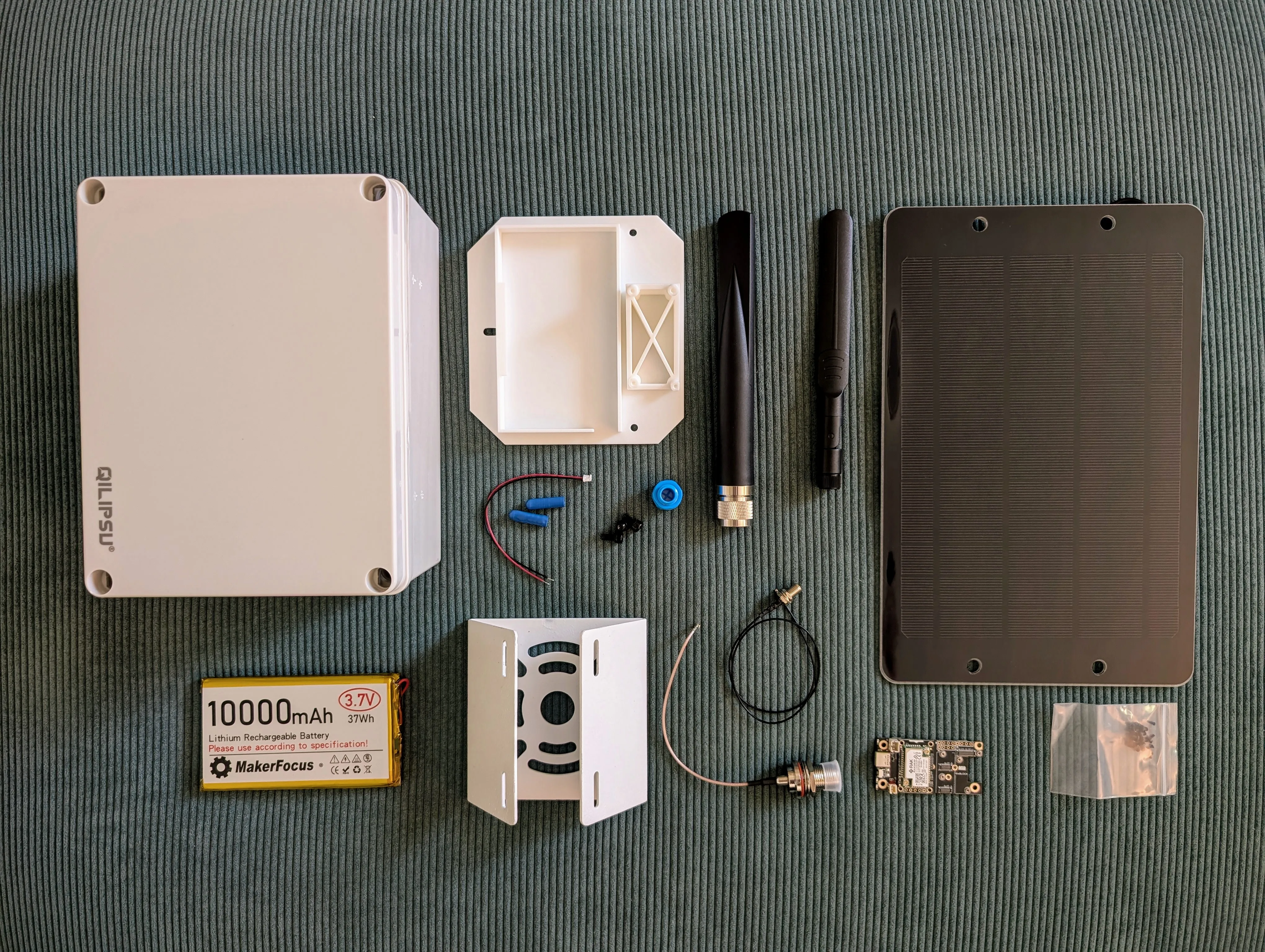 Component list - All components laid out including weatherproof enclosure, solar panel, Meshtastic board, 10000mAh battery, antenna, cables, and hardware