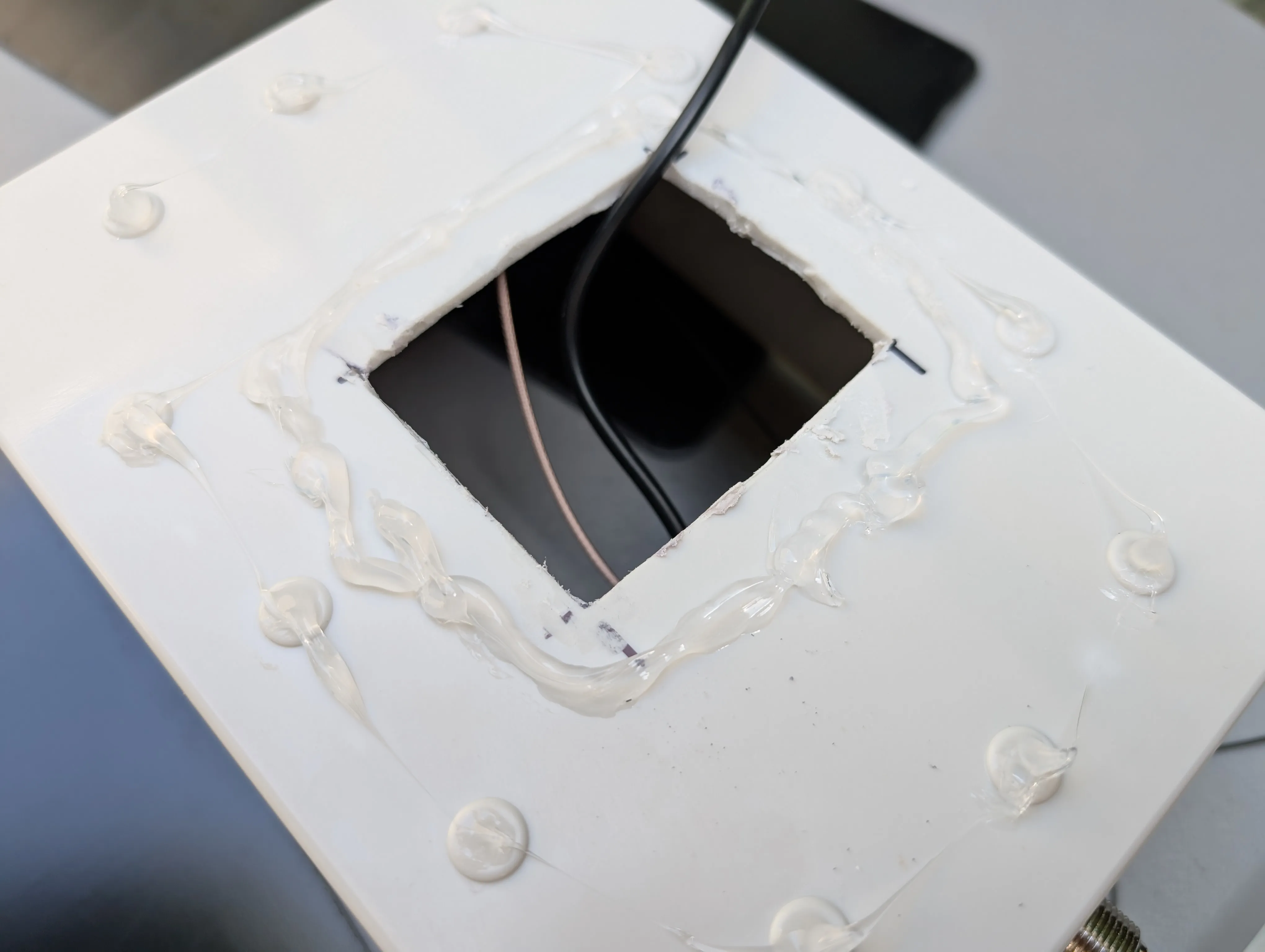 Sealing the solar panel - Underside of enclosure showing solar panel attached to the window cut in the enclosure