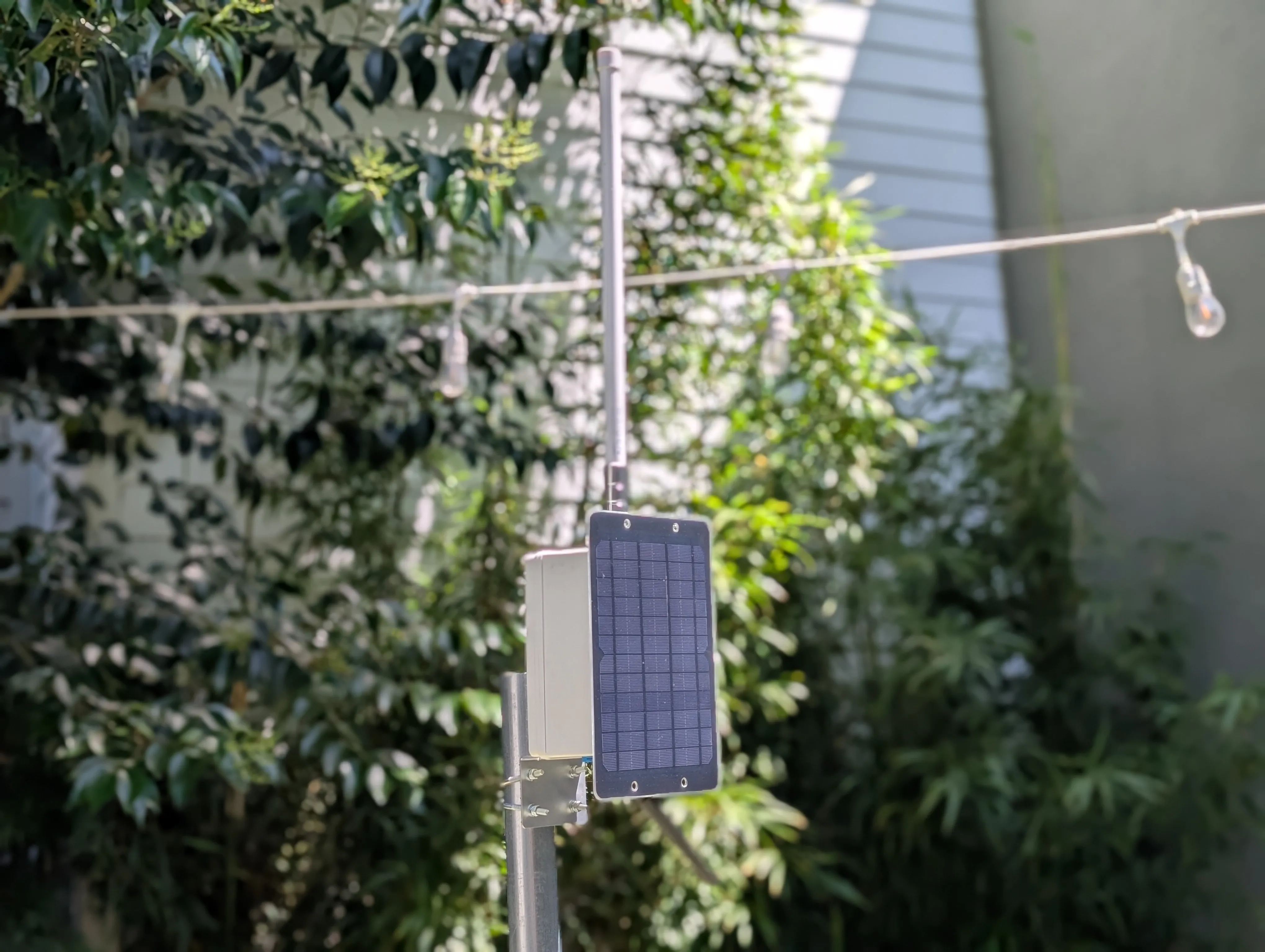 Test Installation - Completed solar Meshtastic node installed outdoors on pole mount with solar panel and alternative RAIGEN antenna